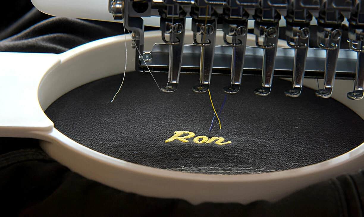 embroidery machine just finishing a nickname on a garment